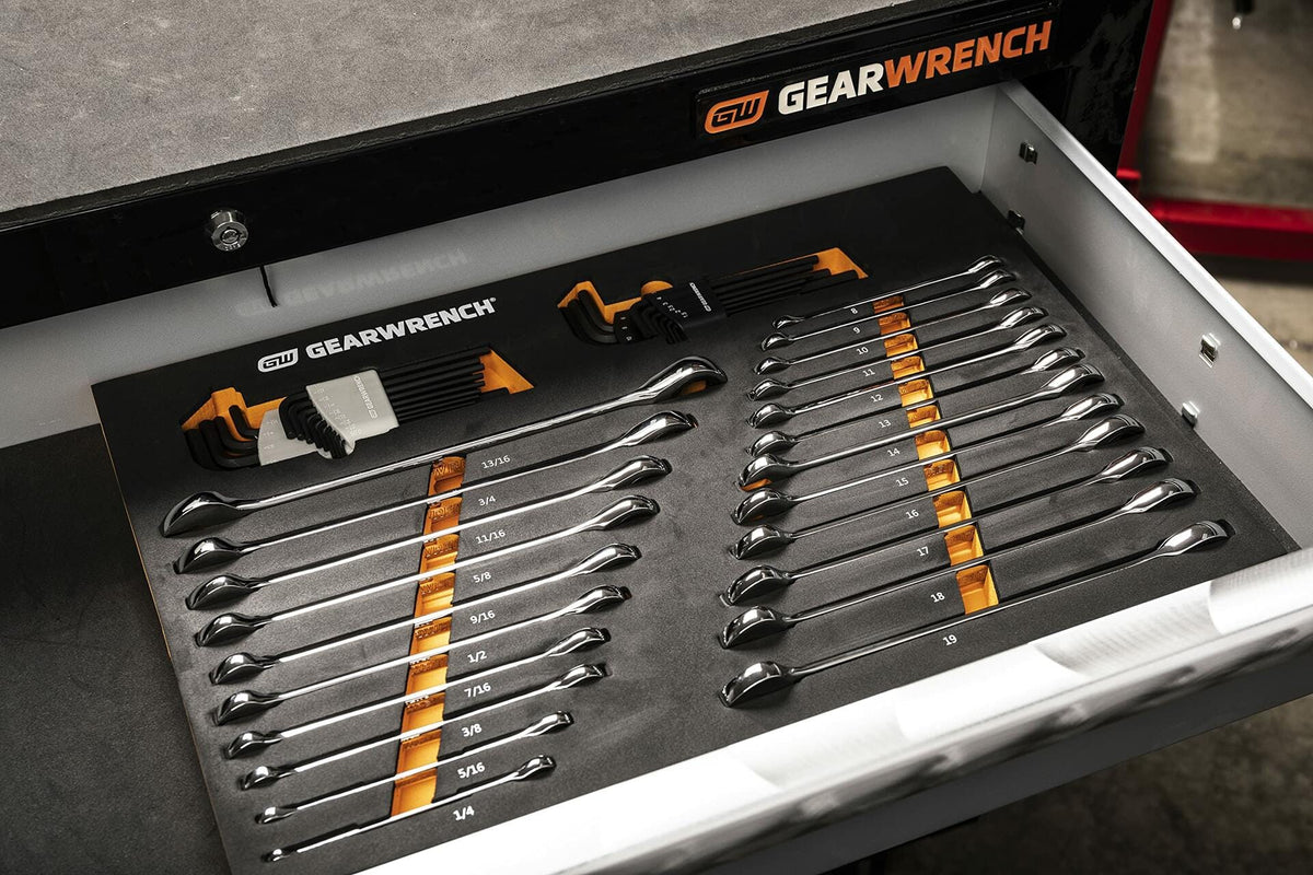 Open drawer of a GEARWRENCH tool chest showing a foam tray with combination wrenches and hex key sets. Wrenches range from 1/4" to 1", and hex keys are stored in orange and black holders. Each tool is labeled and securely organized.