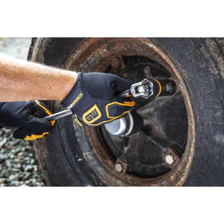 A mechanic using a hand ratchet and extension with a GEARWRENCH Bolt Biter socket to turn a fastener on a rusted vehicle wheel.