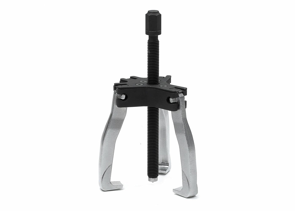Three-jaw gear puller tool with central threaded screw and adjustable arms. Used for removing press-fitted components such as gears, pulleys, and bearings from shafts in automotive and mechanical repair.