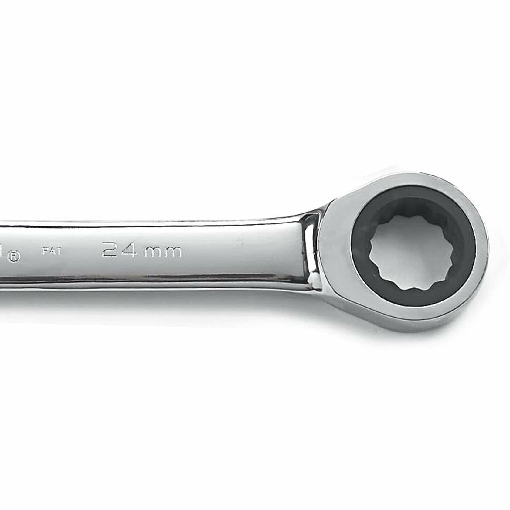 Close-up of a 24 mm ratcheting box-end wrench with polished chrome finish. The ratcheting mechanism is visible inside the circular end, designed for gripping and turning bolts in confined mechanical or automotive spaces
