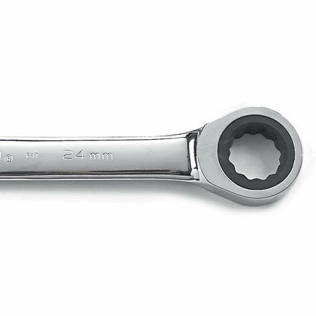 Close-up of a 24 mm ratcheting box-end wrench with polished chrome finish. The ratcheting mechanism is visible inside the circular end, designed for gripping and turning bolts in confined mechanical or automotive spaces