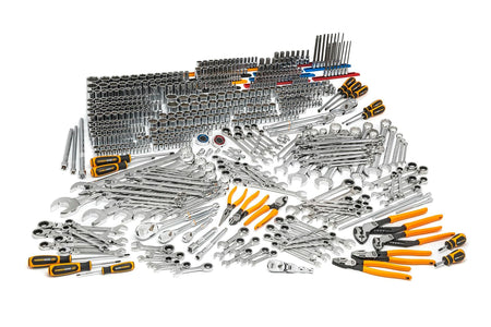 Wide-angle view of a comprehensive mechanics tool set laid out on a white background. Includes socket wrenches, ratchets, combination wrenches, screwdrivers, pliers, torque wrenches, hex keys, and specialty tools. Designed for professional-grade automotive and industrial use.