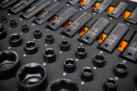 Foam tray containing deep and shallow metric impact sockets labeled from 10mm to 22mm; sockets marked with brand and part numbers for easy identification and organized access