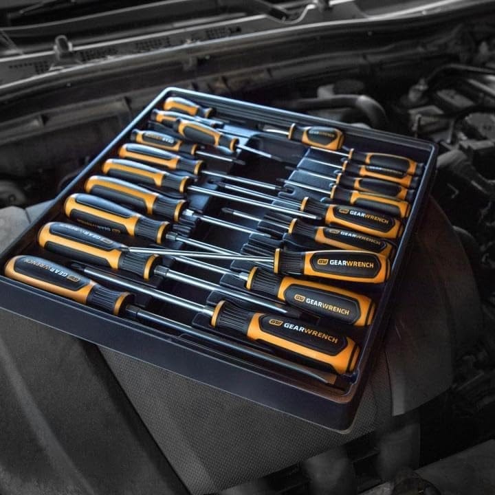 A lifestyle shot of the GEARWRENCH 80066H 20-piece set resting in its storage tray on top of a vehicle's engine, highlighting organized tool management in a professional automotive environment.