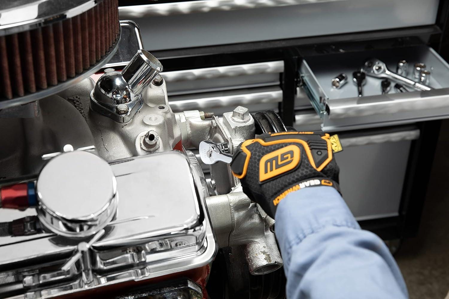 An action photo of a technician using the GEARWRENCH 3/8 inch drive 90-tooth cushion grip ratchet to perform maintenance on a high-performance engine, showcasing the tool's low profile access.
