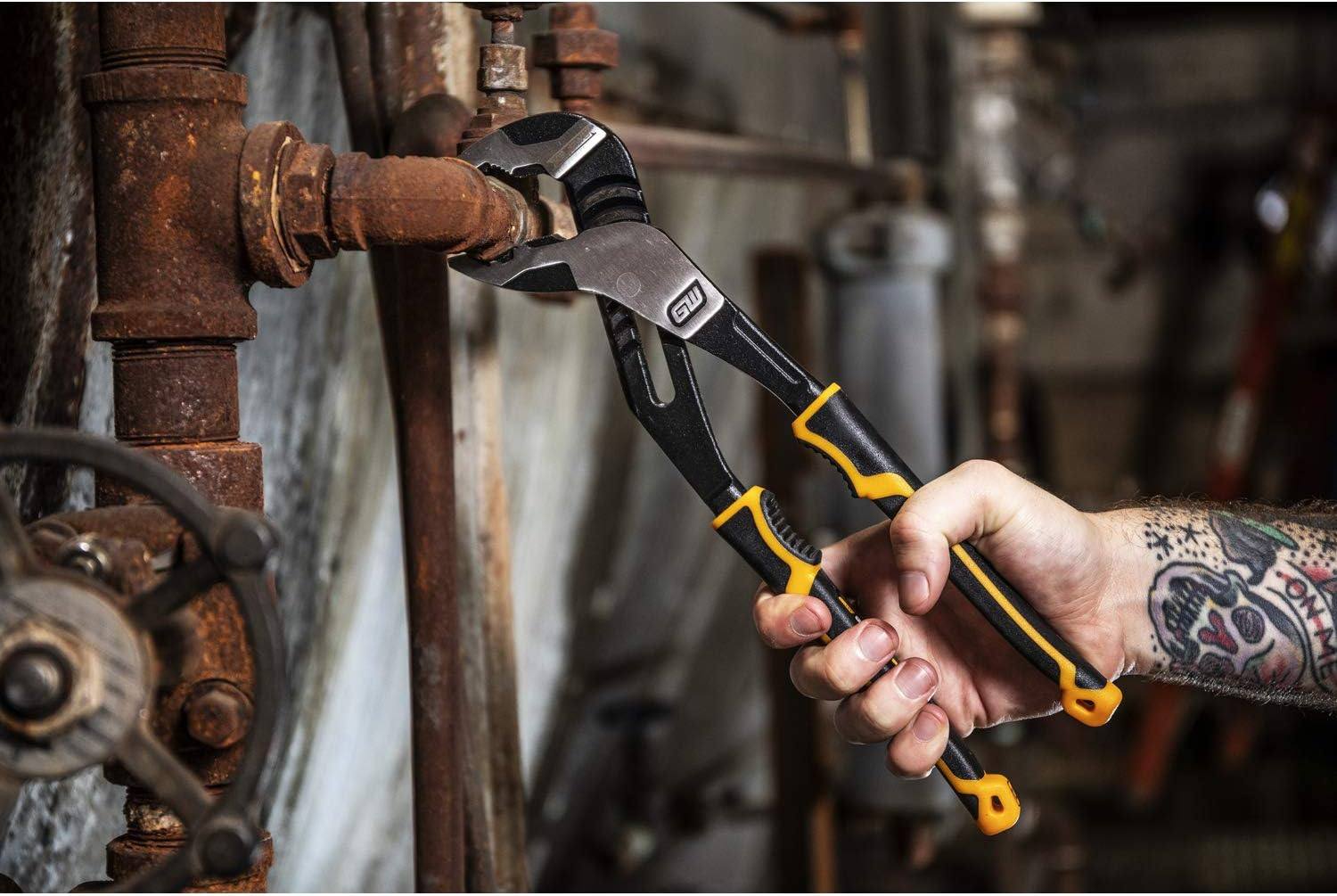 An industrial technician using the GEARWRENCH 82168C PITBULL V-Jaw pliers to loosen a rusted heavy-duty pipe fitting in a professional maintenance environment.