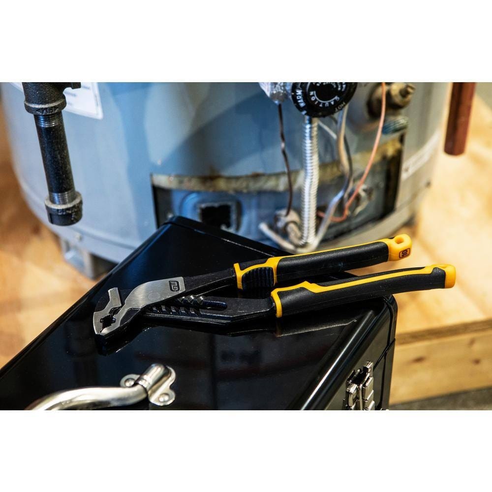 GEARWRENCH 82168C tongue and groove pliers resting on a black tool chest in front of a residential water heater, illustrating its portability and readiness for professional plumbing repairs.