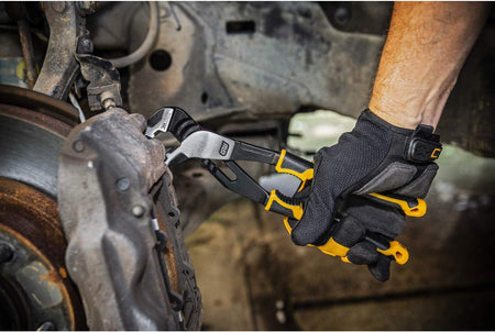 An automotive mechanic using the high-leverage GEARWRENCH PITBULL straight jaw pliers to compress a heavy-duty brake caliper during a vehicle repair.