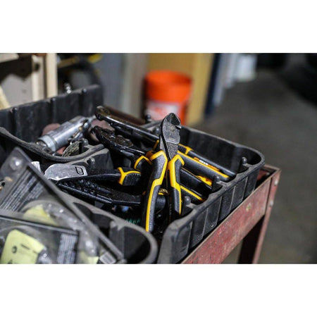 Close-up of GEARWRENCH PITBULL diagonal cutting pliers stored in a professional tool tray alongside other industrial hand tools in a workshop setting.
