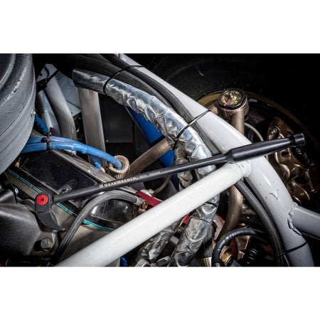 A professional technician using the GEARWRENCH 8-inch indexing pry bar to align components deep inside a vehicle's engine bay, showcasing the swivel head's ability to reach areas inaccessible to fixed-head tools.