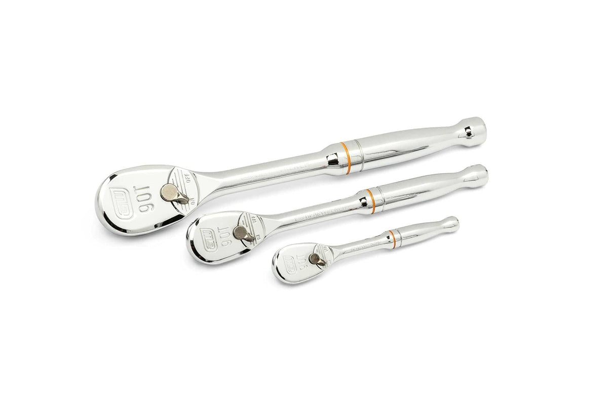 Three polished chrome ratchet wrenches arranged diagonally. Each has a round head with directional switch and square drive. The largest ratchet features an orange ring near the head. Labeled “90T” and “GWD,” indicating tooth count and brand.