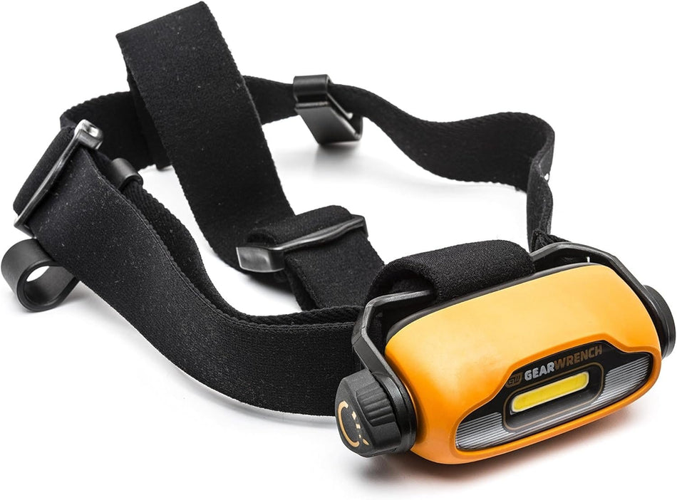 A professional product photograph of the GEARWRENCH 83137 rechargeable LED headlamp featuring an orange and black housing with COB technology and a comfortable, adjustable black head strap.