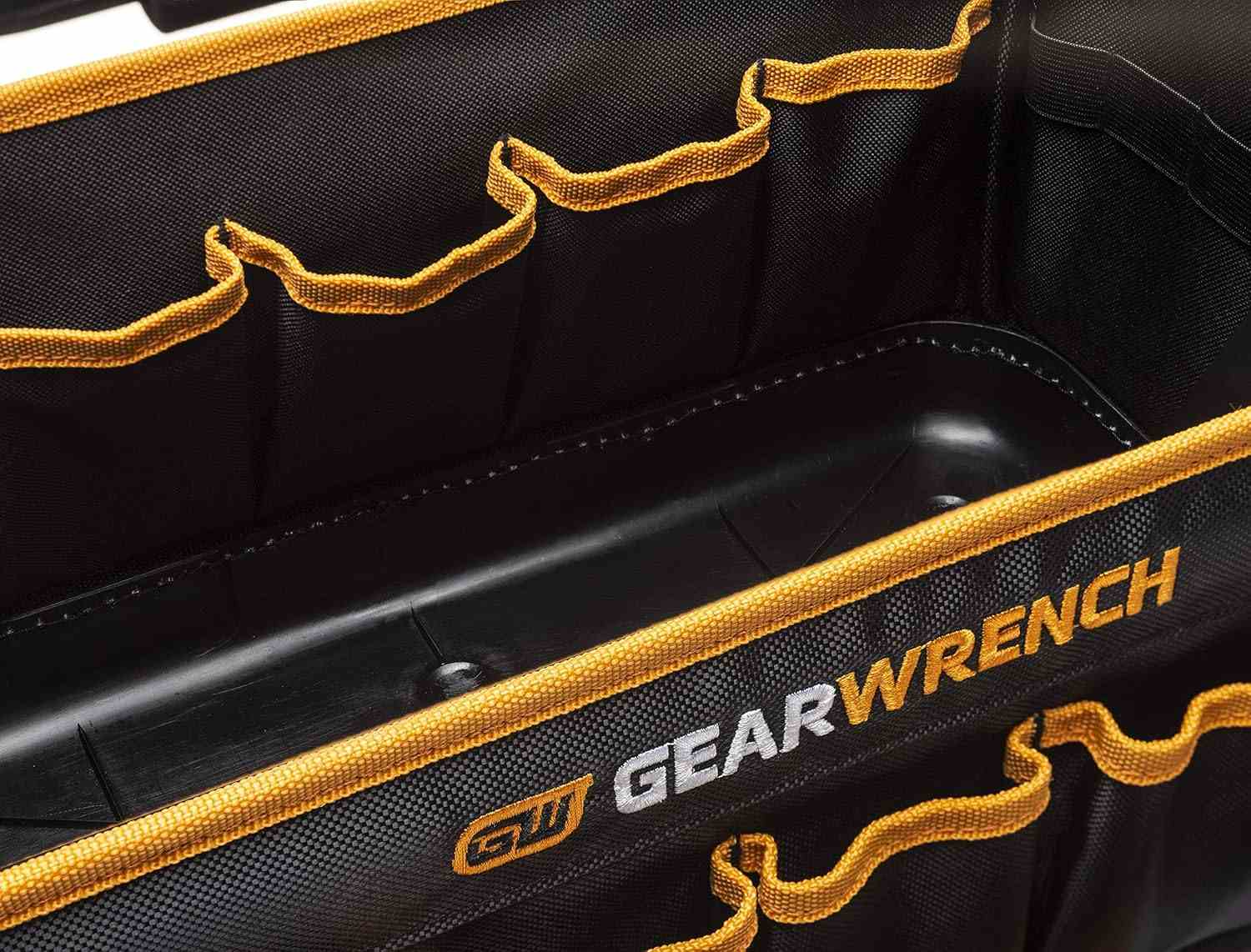 A close-up of the internal compartment of the GEARWRENCH tool tote bag showing the deep pockets and the heavy-duty reinforced molded bottom for superior jobsite durability.