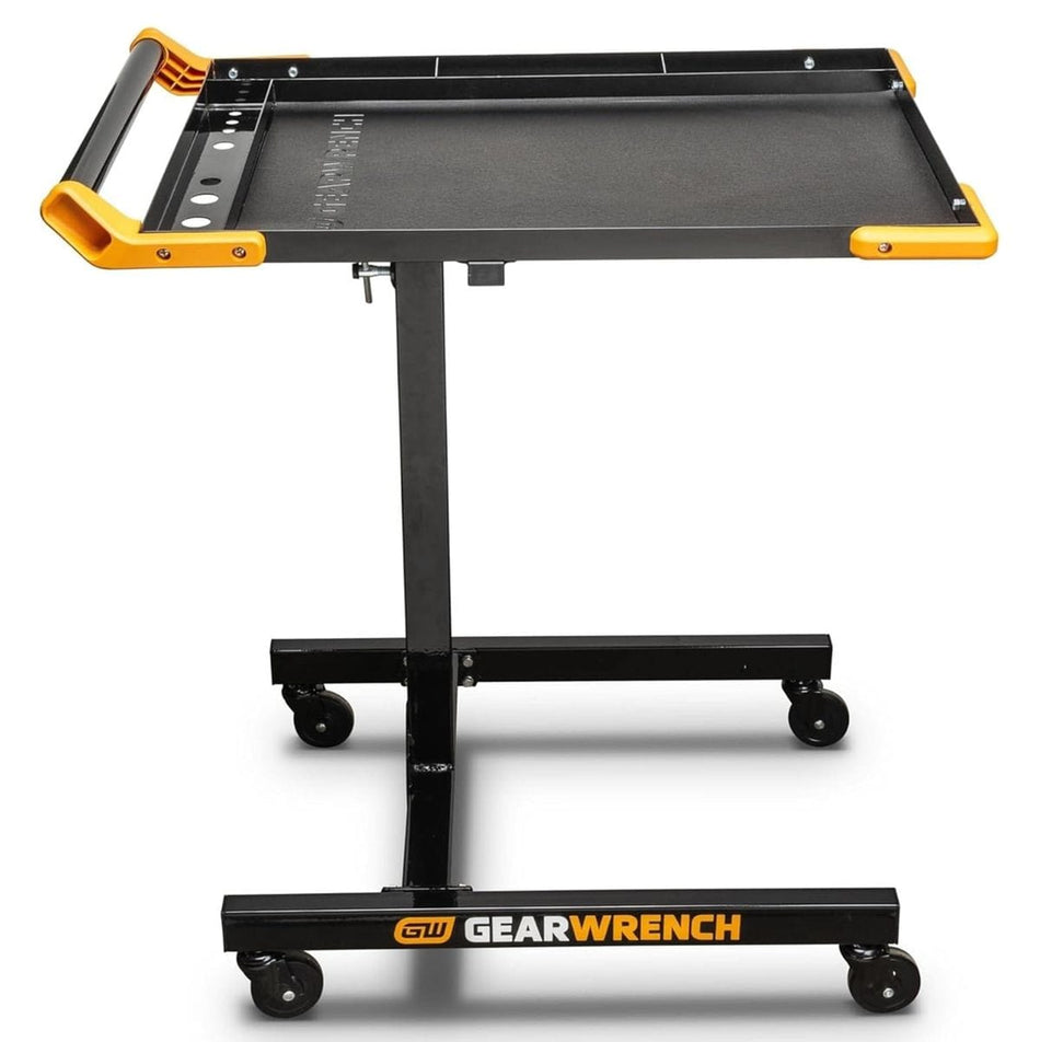 A side profile of the GEARWRENCH 83166 mobile work table featuring a black powder-coated steel frame, a 20x30 inch tray with an EVA mat, and a height-adjustable telescoping pillar on four swivel casters.