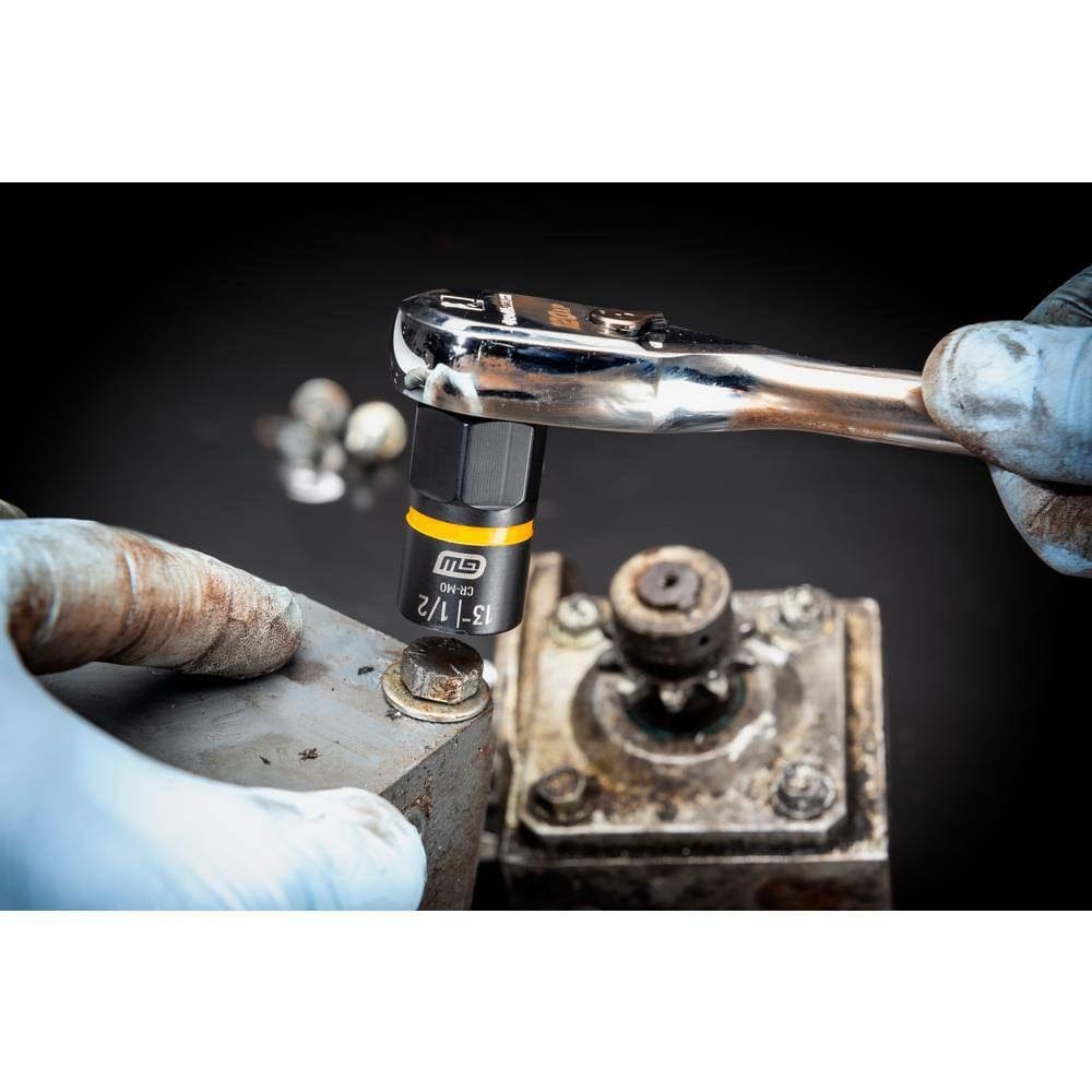 Close-up of a mechanic using a GEARWRENCH Bolt Biter impact extraction socket with a standard hand ratchet to securely grip and remove a rusted and stripped bolt from a heavy-duty industrial surface.