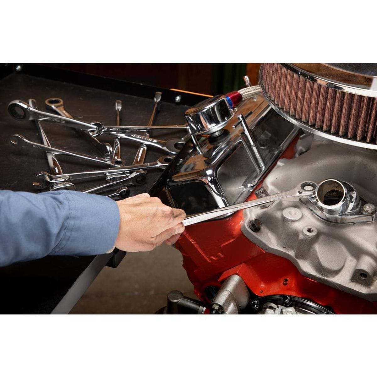 A professional mechanic using an XL X-Beam ratcheting wrench on a high-performance engine, demonstrating the tool's precision and extended reach in a real-world automotive application.