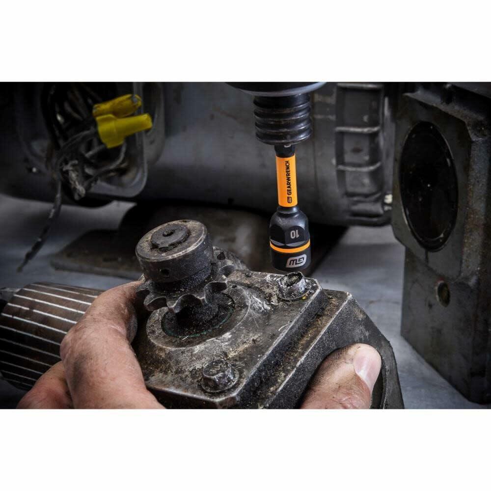 A mechanic uses a 10mm GEARWRENCH Bolt Biter nut extractor in an impact driver to work on a dirty, greasy metal gear.