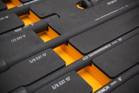 A close-up detail of a 3/8 inch drive impact extension bar seated in the GEARWRENCH EVA foam tray, highlighting the high-visibility white size labels printed directly on the foam.