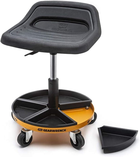 A perspective view of the GEARWRENCH 86994 mechanics seat with one of the five magnetic parts trays removed, demonstrating the modular storage capabilities of the rolling base for fasteners and small tools.