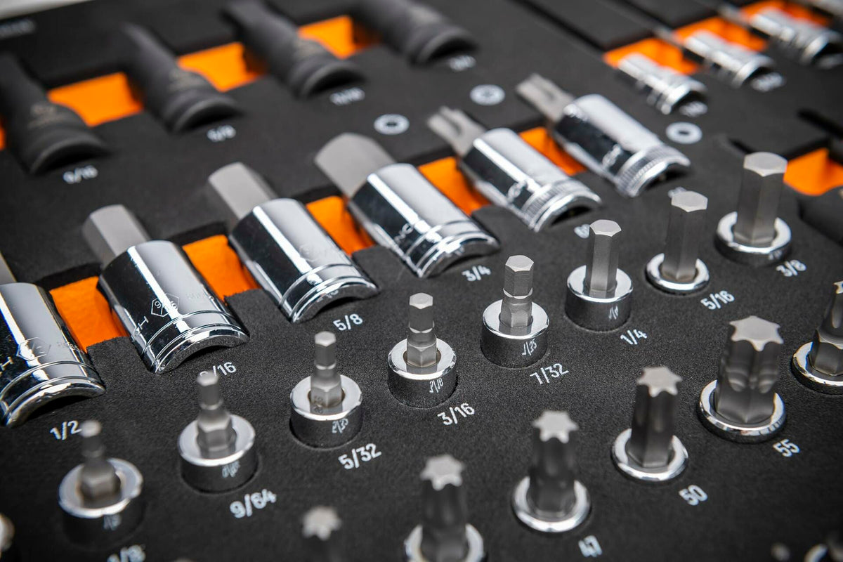 Chrome-finished SAE socket bits arranged in rows on a labeled tray; includes hex, Torx, and standard sockets ranging from 5/32 to 9/16 inches for mechanical and automotive applications.