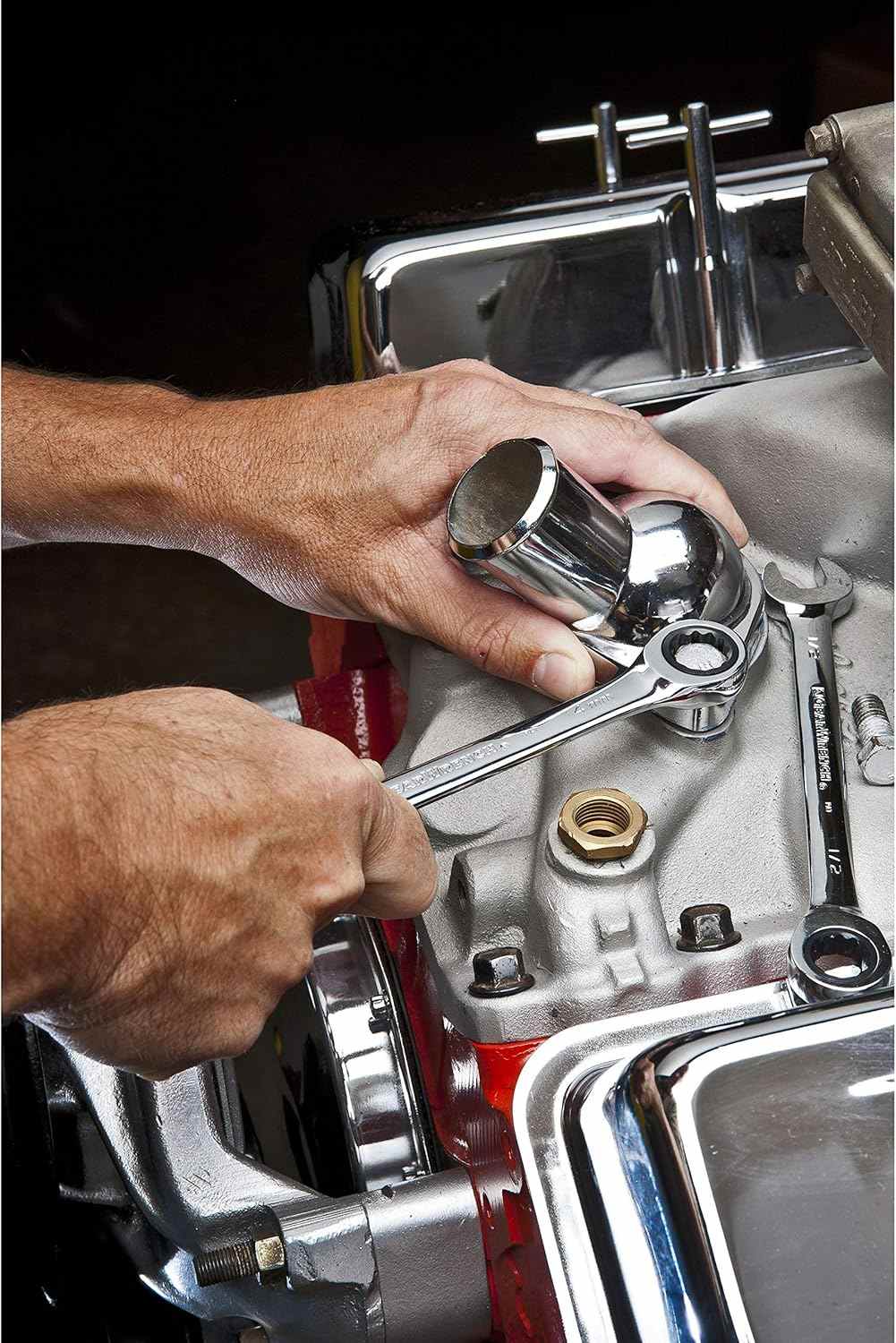 An action shot of a mechanic using a GearWrench ratcheting wrench to install a chrome component on a high-performance engine block.
