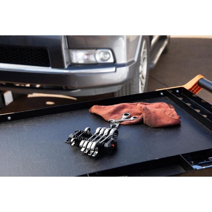 A lifestyle shot of the GEARWRENCH 9507D stubby wrench set organized in its rack on a black service cart next to a red shop rag, demonstrating professional utility in an automotive workshop.