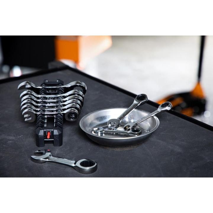 A lifestyle shot of the GEARWRENCH 9520D metric stubby wrench set organized in a service rack and metal parts tray on a professional workbench, demonstrating efficient tool management.