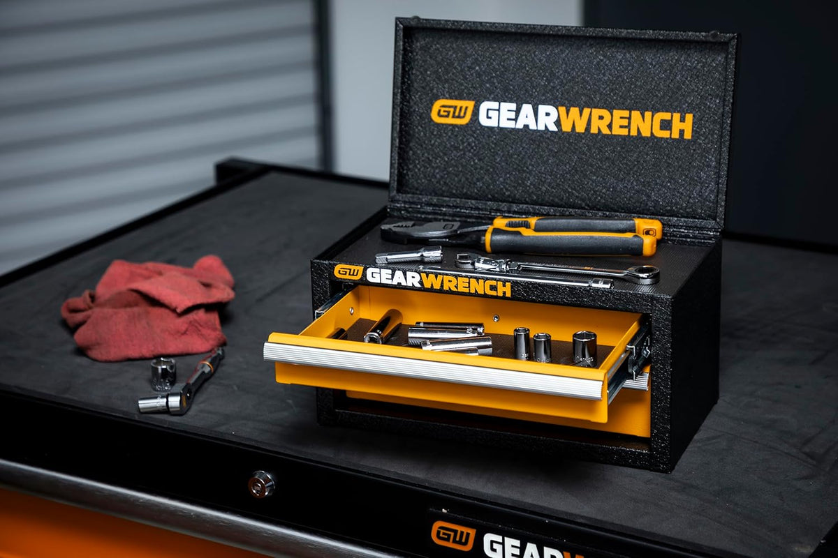GEARWRENCH mini tool chest resting on a workbench showing smooth ball-bearing drawers loaded with drive sockets, pliers, and wrenches.