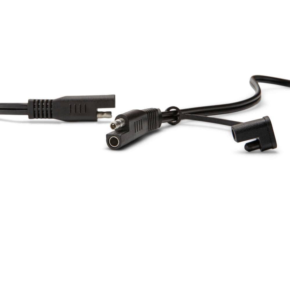 A close-up view of the quick-disconnect terminal system. The image shows the specialized two-pin automotive connectors that allow users to easily swap between the heavy-duty clamps and the permanent ring terminal leads.
