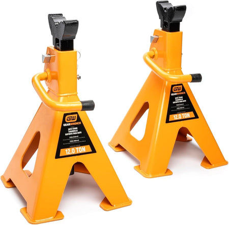 A pair of GEARWRENCH 12-ton molten orange ratcheting jack stands featuring high-strength forged steel construction and wide saddles for secure vehicle support in professional automotive shops.