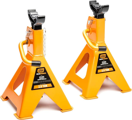 A pair of high-visibility molten orange GEARWRENCH 2-ton ratcheting jack stands featuring a high-strength welded steel design and wide saddles for secure vehicle support in professional automotive shops.