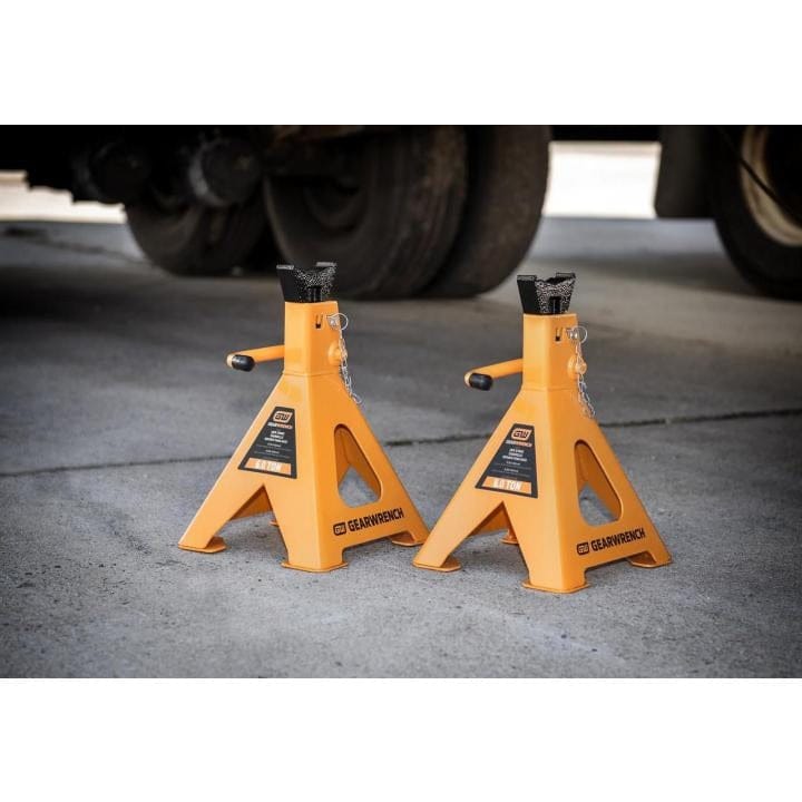 Side-angled view of the GEARWRENCH 6.0 ton ratcheting jack stands on a level surface, illustrating the large welded feet designed to displace heavy loads safely.