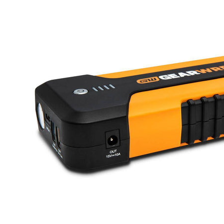 A detail shot of the side profile of the GEARWRENCH portable power bank. The image showcases the dedicated 15V 10A DC output port and the rugged textured grip integrated into the molten orange housing for secure handling in greasy shop environments.