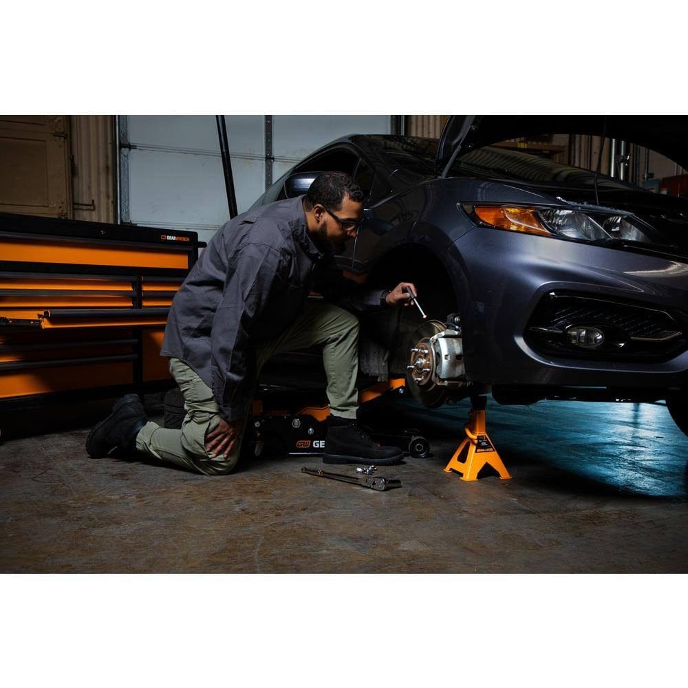 An action shot demonstrating the integrated dimming function of the GEARWRENCH pen light, showing the adjustable brightness levels for optimal visibility in various mechanical inspection scenarios.