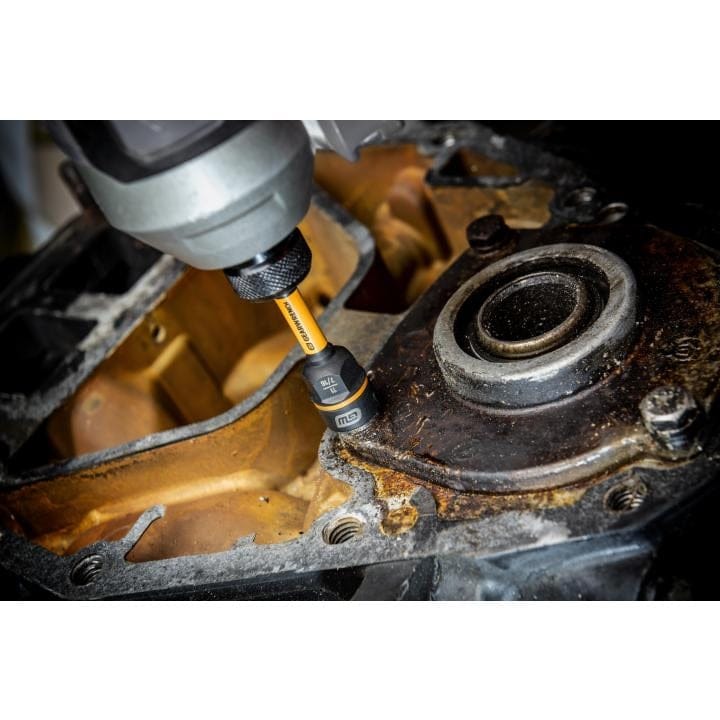 Cordless power tool with GearWrench bit engaging a fastener on a rusted metal housing near a bearing, illustrating mechanical disassembly in industrial repair work.
