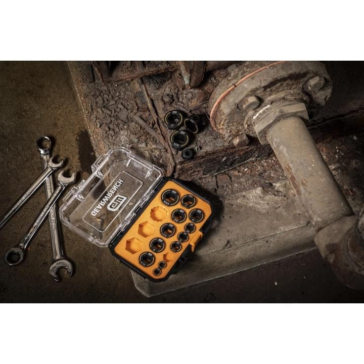 DEWALT socket bit set in yellow case with combination wrenches on rusted metal surface near pipe structure.