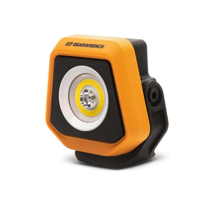 GearWrench LED shop light with orange and black casing, central LED surrounded by yellow ring, mounted on a black base for adjustable positioning in tight workspaces.