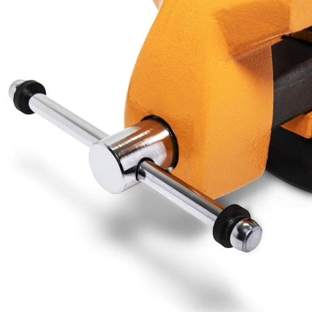 Close-up of the polished metal handle on a yellow GearWrench bench vise, showing the rotating mechanism used to adjust jaw grip.
