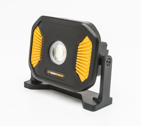 GearWrench portable LED work light with rugged black casing, yellow side accents, and adjustable brackets for directional illumination in low-light environments.