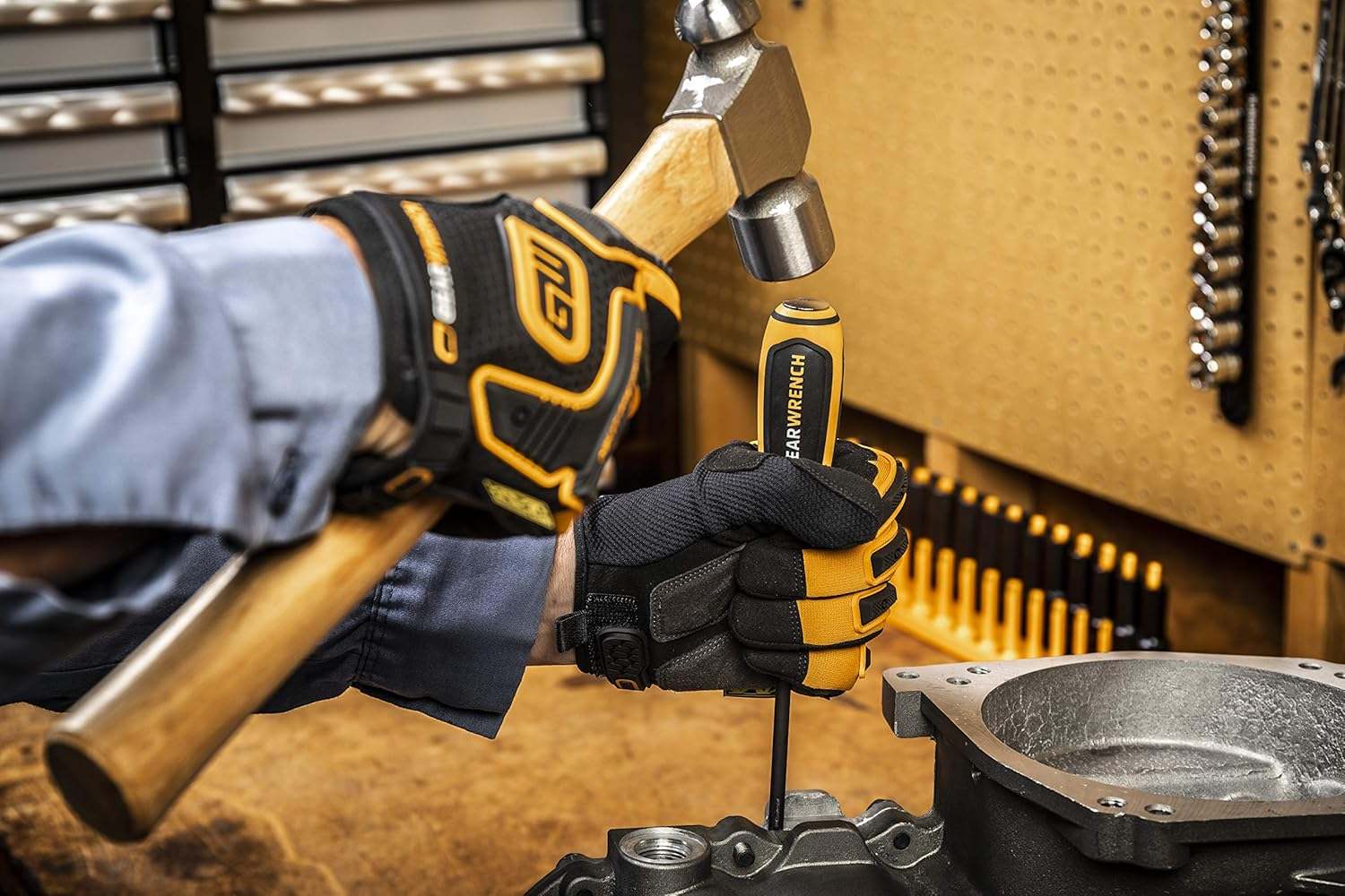 Professional application showing the GearWrench Bolt Biter slotted screwdriver being used in an industrial setting to extract frozen fasteners from heavy machinery.