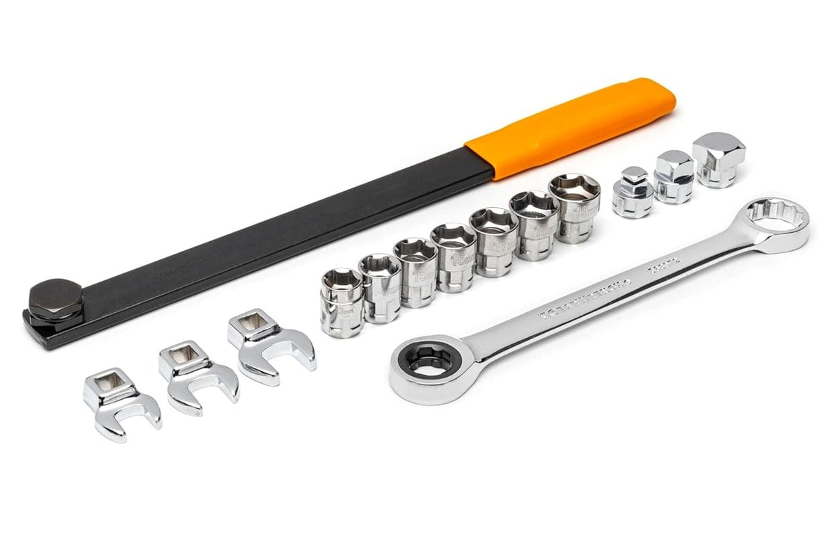 Complete 15-piece serpentine belt tool set displayed, featuring a long black extension bar with an orange handle, a chrome ratcheting wrench, three crowfoot wrenches, three drive adapters, and seven sockets.