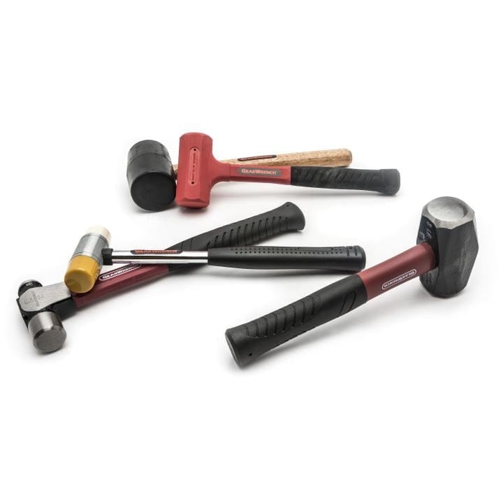A pile of GearWrench hammers and mallets showcasing the variety of striking tools included in the set.
