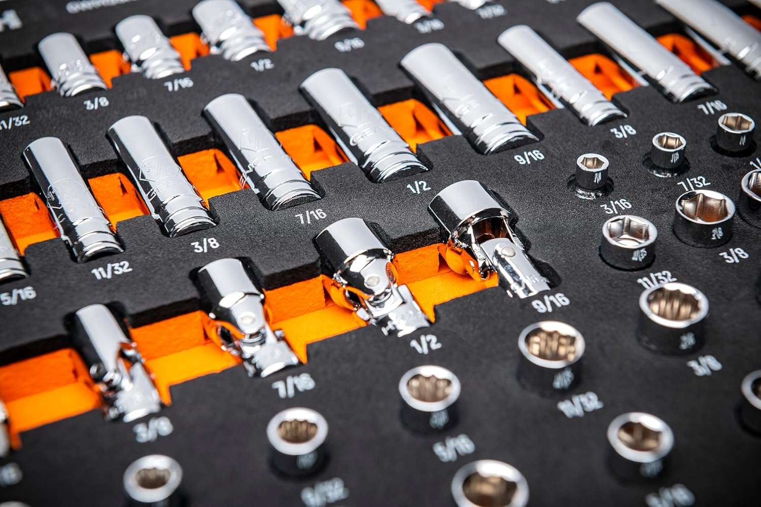 Close-up angled view of deep and standard chrome sockets organized in a high-contrast foam tray with visible size markings.