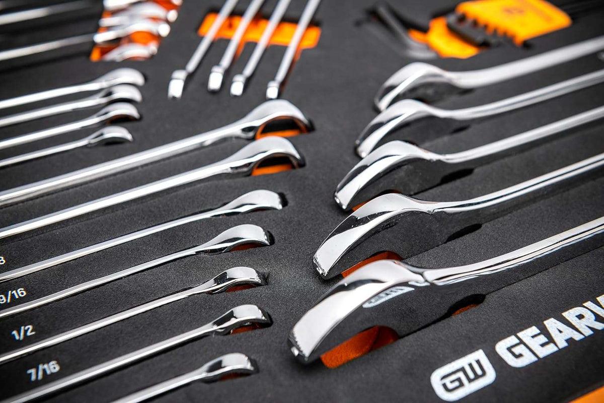 Close-up view of a foam organizer tray holding polished chrome combination wrenches.