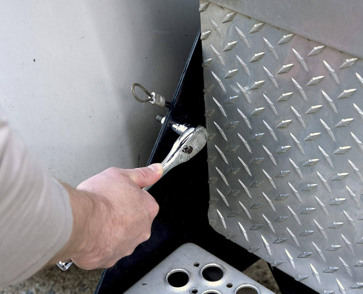 Close-up of a GearWrench 90-tooth 3/8-drive ratchet being used to adjust a bolt in a narrow space, demonstrating the 4-degree swing arc capabilities.