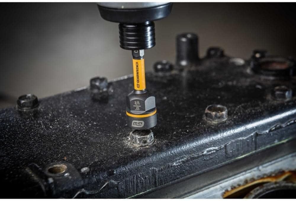 A detailed view of the GearWrench 1/2-inch Bolt Biter driver in use with a power impact tool on an industrial component, illustrating the high-torque removal of a rounded nut.
