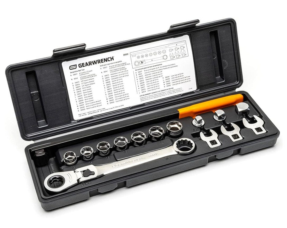 Open black blow-mold storage case displaying the full 15-piece serpentine belt tool set, including the long extension bar with an orange handle, locking flex-head ratcheting wrench, sockets, and adapters, with a parts reference chart adhered to the inner lid.