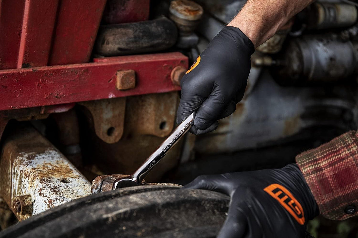GearWrench ratcheting wrench being used for heavy-duty maintenance on agricultural machinery, highlighting the tool's reliability in professional environments.