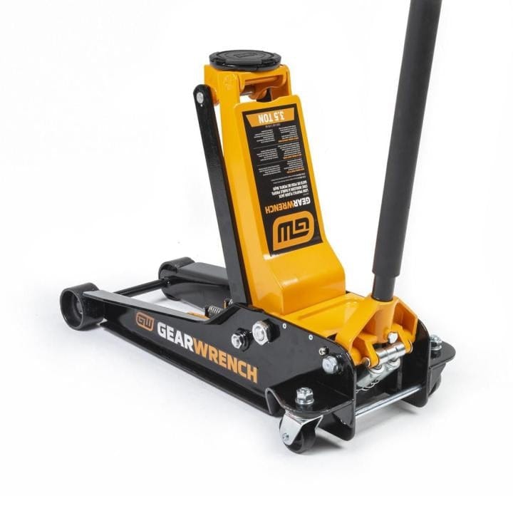 Gearwrench floor jack with black and orange body, long handle, and four wheels; lifting pad at top center.