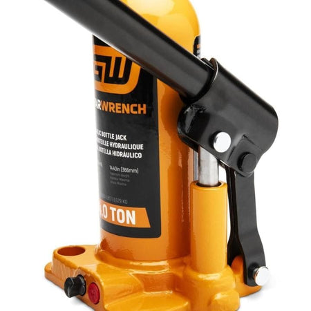 Close-up of PowerWrench 20 Ton hydraulic bottle jack with orange body and black handle; labeled lifting specs visible.